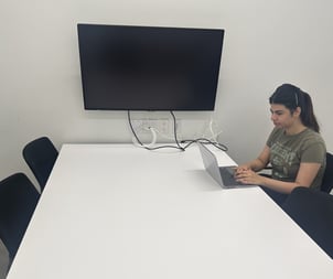 A girl peacefully working on her assignment in the YorkU SCS breakroom, focused and relaxed in the quiet space.