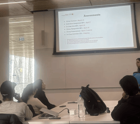 Students attentively listening to the professor in a YorkU SCS classroom as they discuss the upcoming assignment deadline.