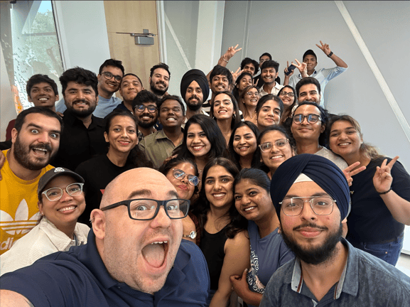 Students taking a selfie together with professor.