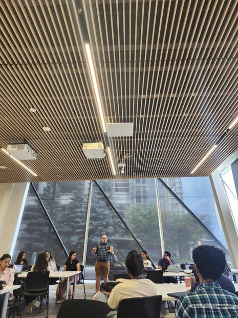 Professor teaching in class and students attentively listening.