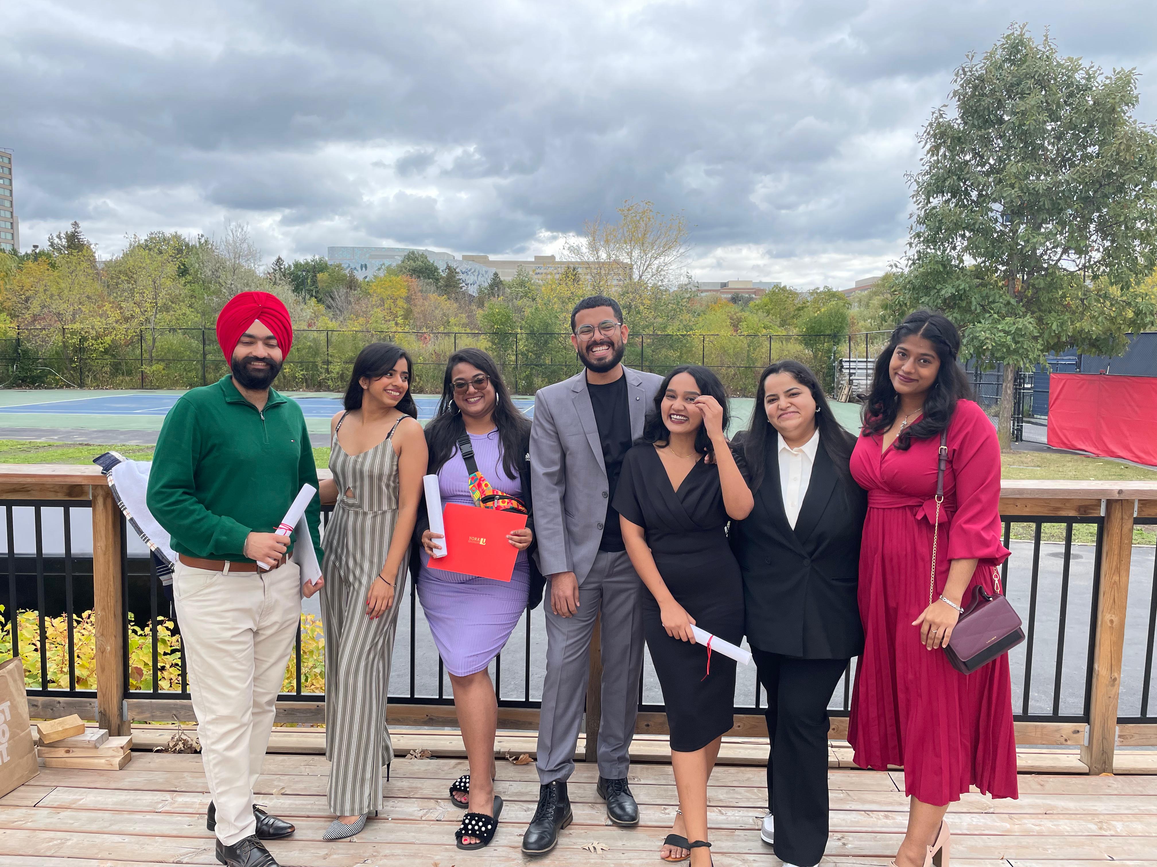 A group of students looking happy with their degrees in hand.
