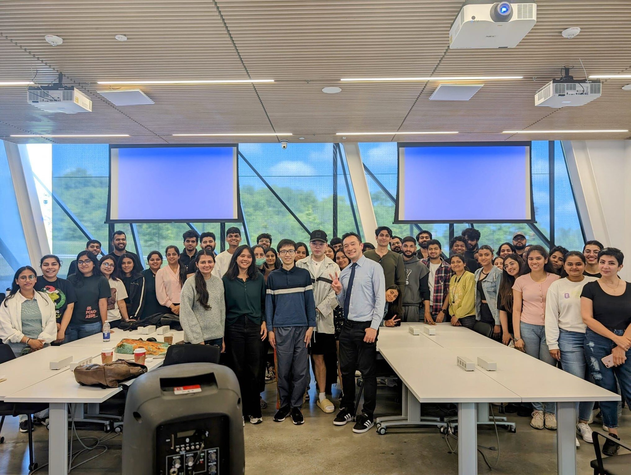 class group photo with Luki Danukarjanto surrounded by students