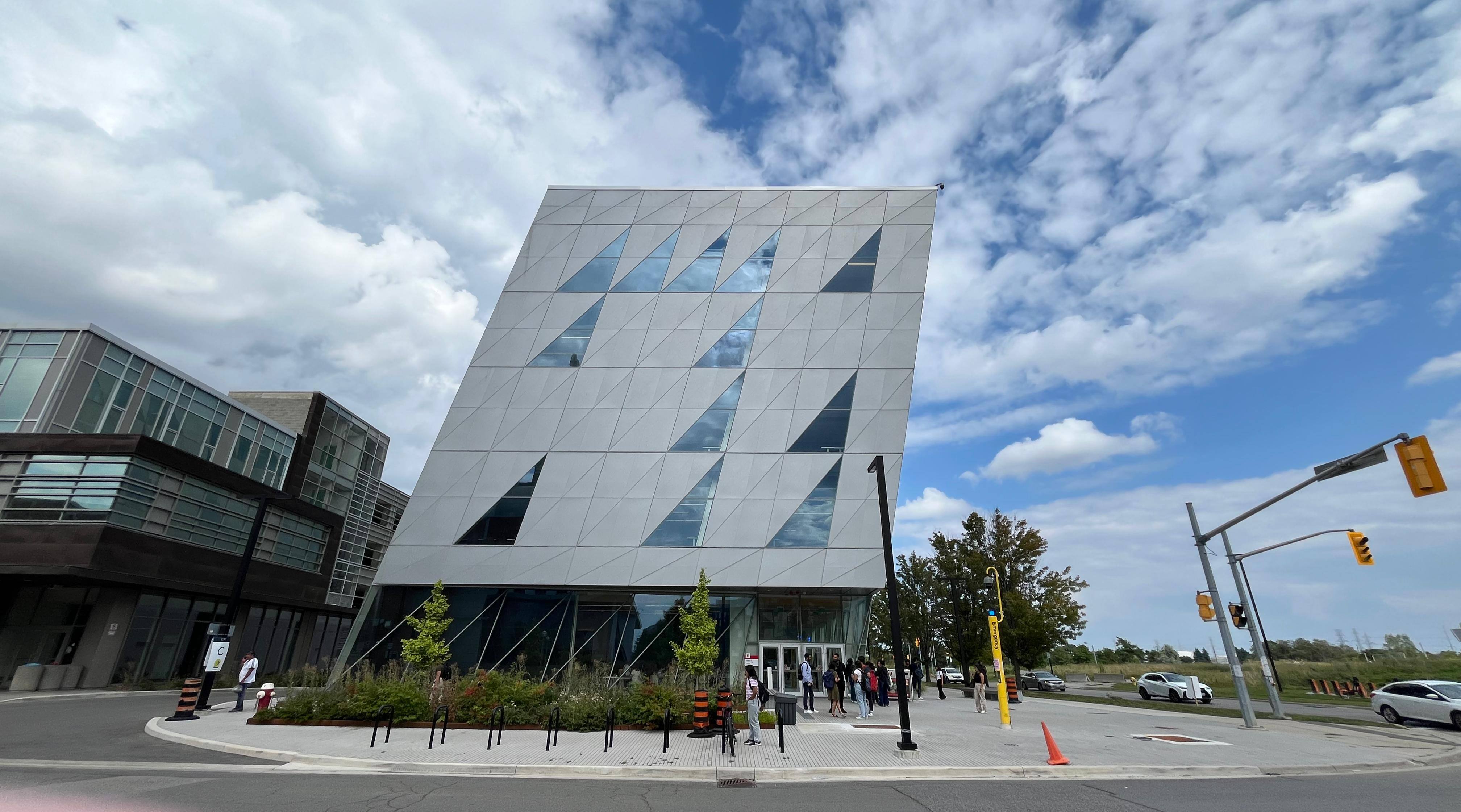 York University School of Continuing Studies with people in the front and cars passing by on the right