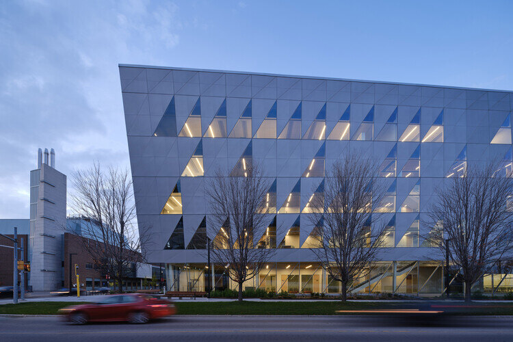 York University SCS building under dim skies with the Seneca at York building on the left, there are cars running on the road at the bottom